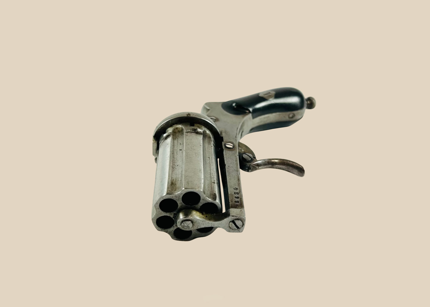 19th-century pepperbox revolver with multiple rotating barrels.