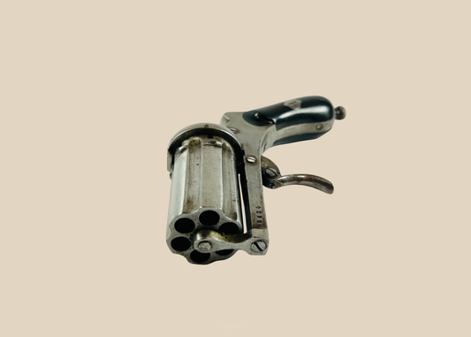 19th-century pepperbox revolver with multiple rotating barrels.