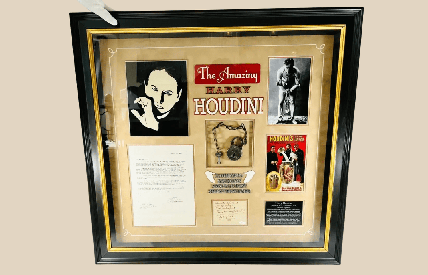 Framed Harry Houdini display featuring rare 1908 signature, photographs, posters, and escape artifact.