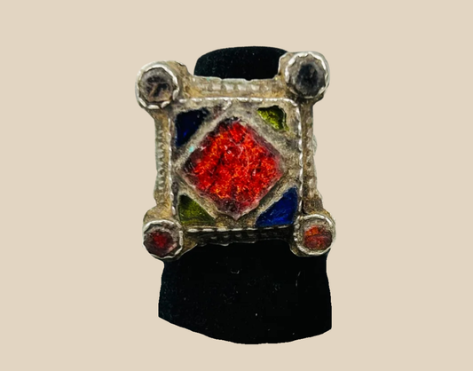 Ancient silver ring with red and multicolored inlay, rare antiquity on display.