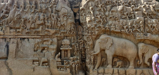 Hindu art relief at Mahabalipuram showing carved deities, sacred figures and elephants.