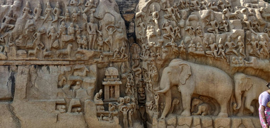 Hindu art relief at Mahabalipuram showing carved deities, sacred figures and elephants.