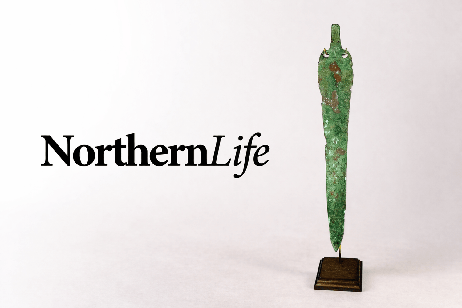 NorthernLife Magazine logo displayed beside an ancient Caspian bronze blade artifact from the 2nd–1st millennium BCE featured by Relic & Rarity.