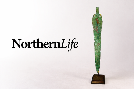 NorthernLife Magazine logo displayed beside an ancient Caspian bronze blade artifact from the 2nd–1st millennium BCE featured by Relic & Rarity.