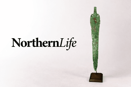 NorthernLife Magazine logo displayed beside an ancient Caspian bronze blade artifact from the 2nd–1st millennium BCE featured by Relic & Rarity.