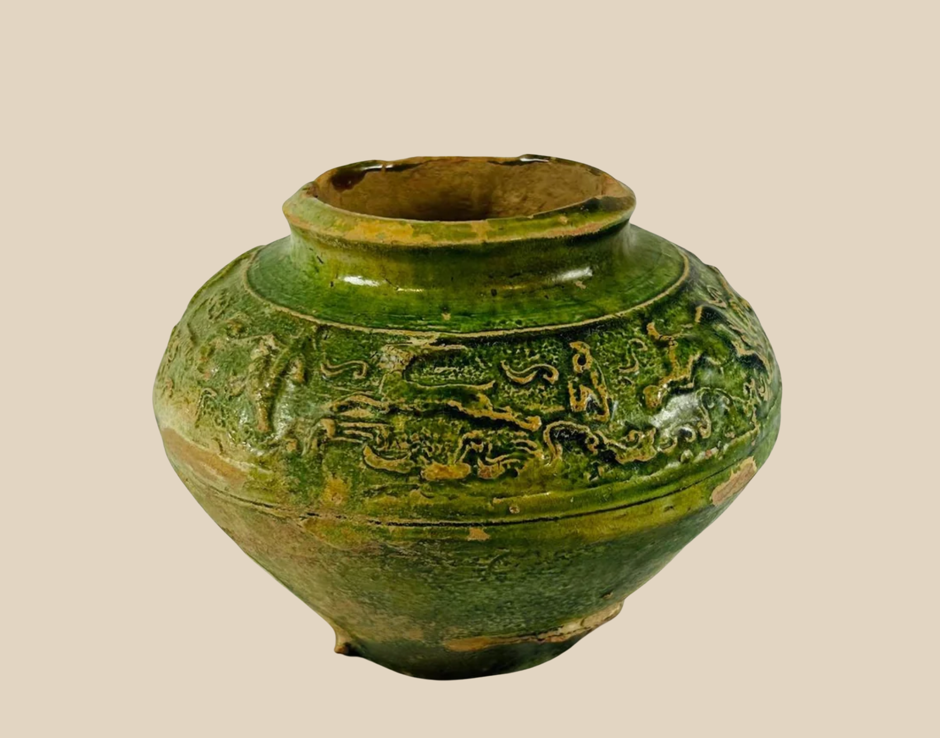 Ancient Chinese green-glazed ceramic vessel with intricate dragon motif, likely Qing Dynasty, displayed on white background.