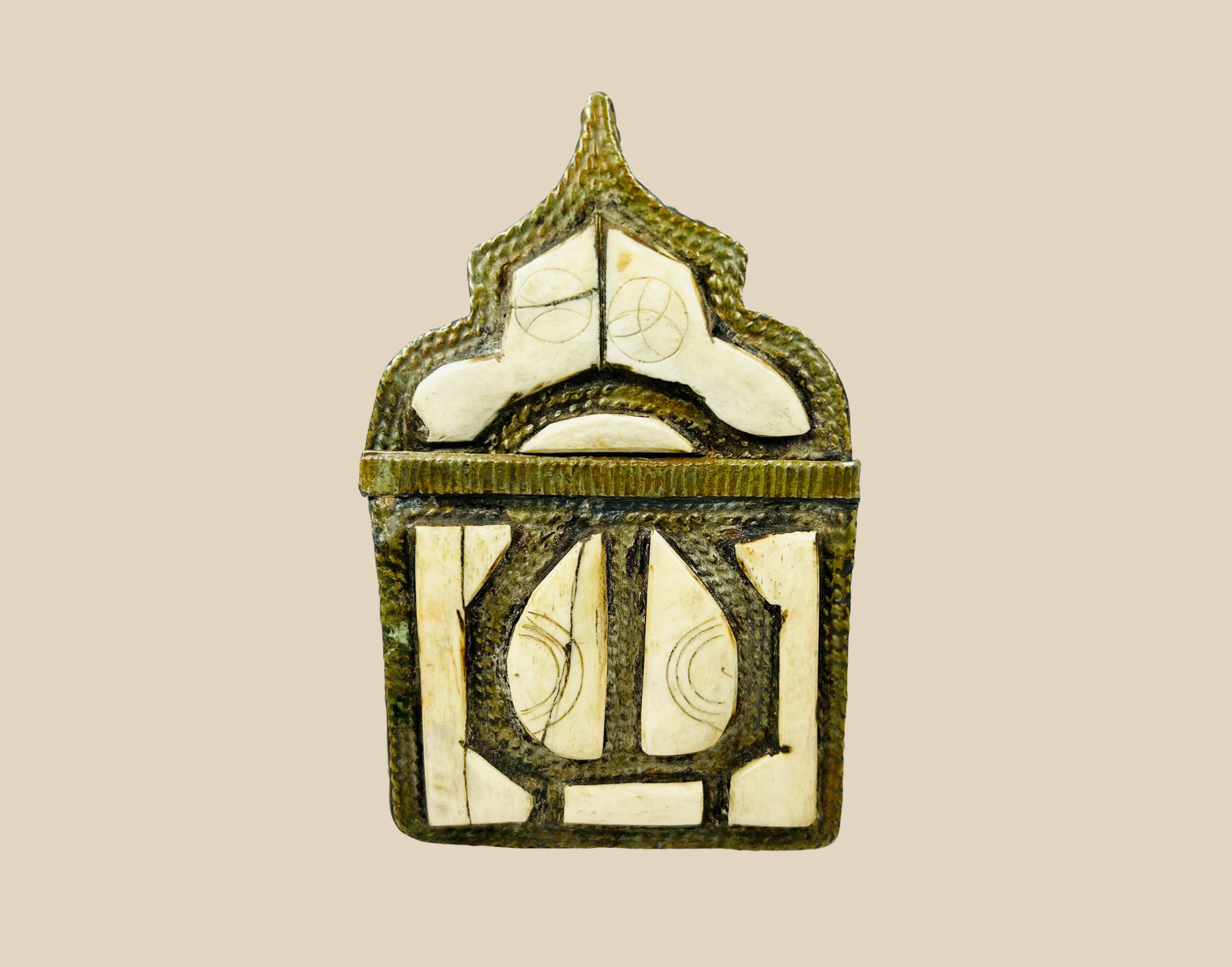 19th-century bronze or brass amulet with intricate openwork design and arched top, displayed on a neutral background
