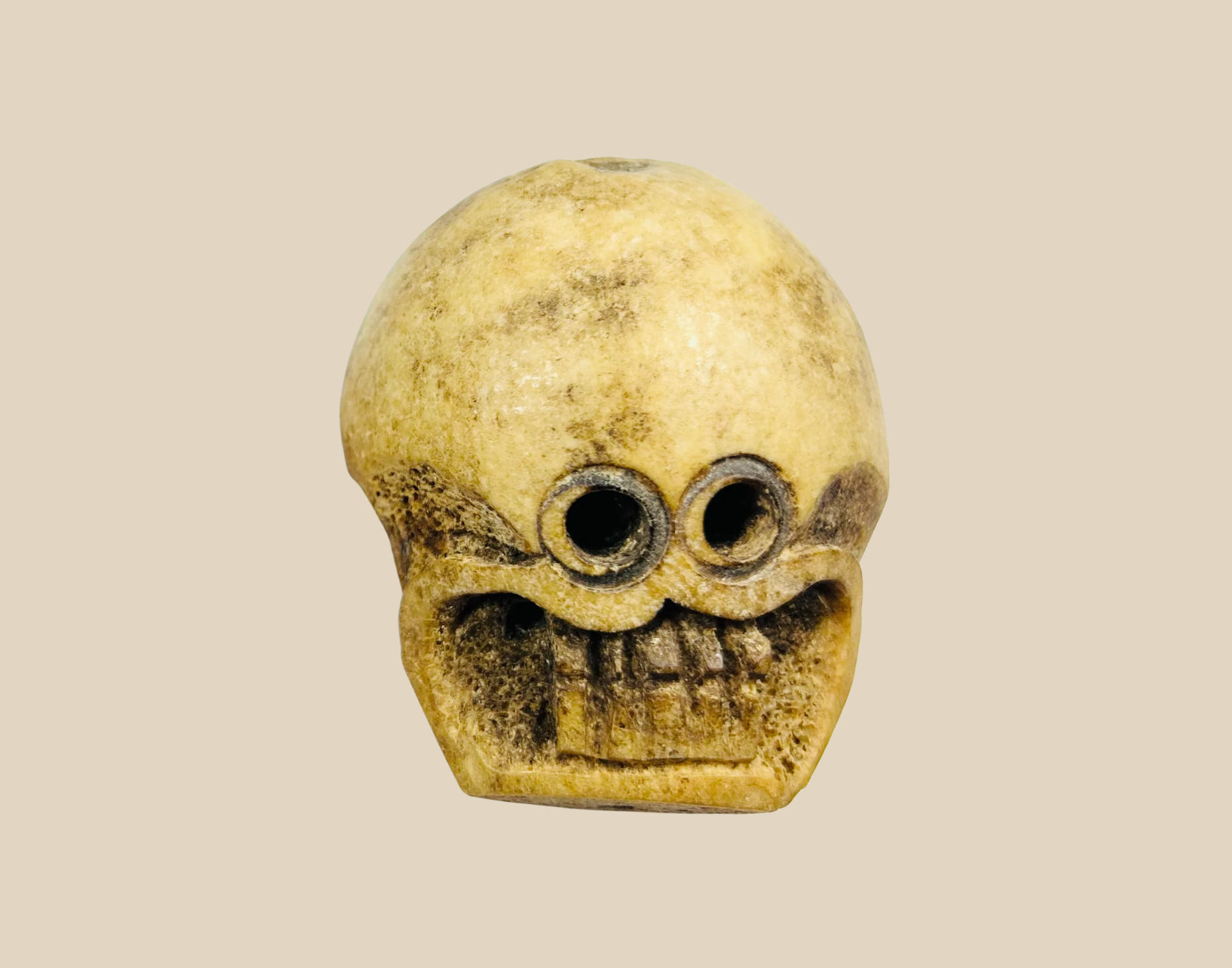 18th-century carved skull artifact with hollow eye sockets and aged patina