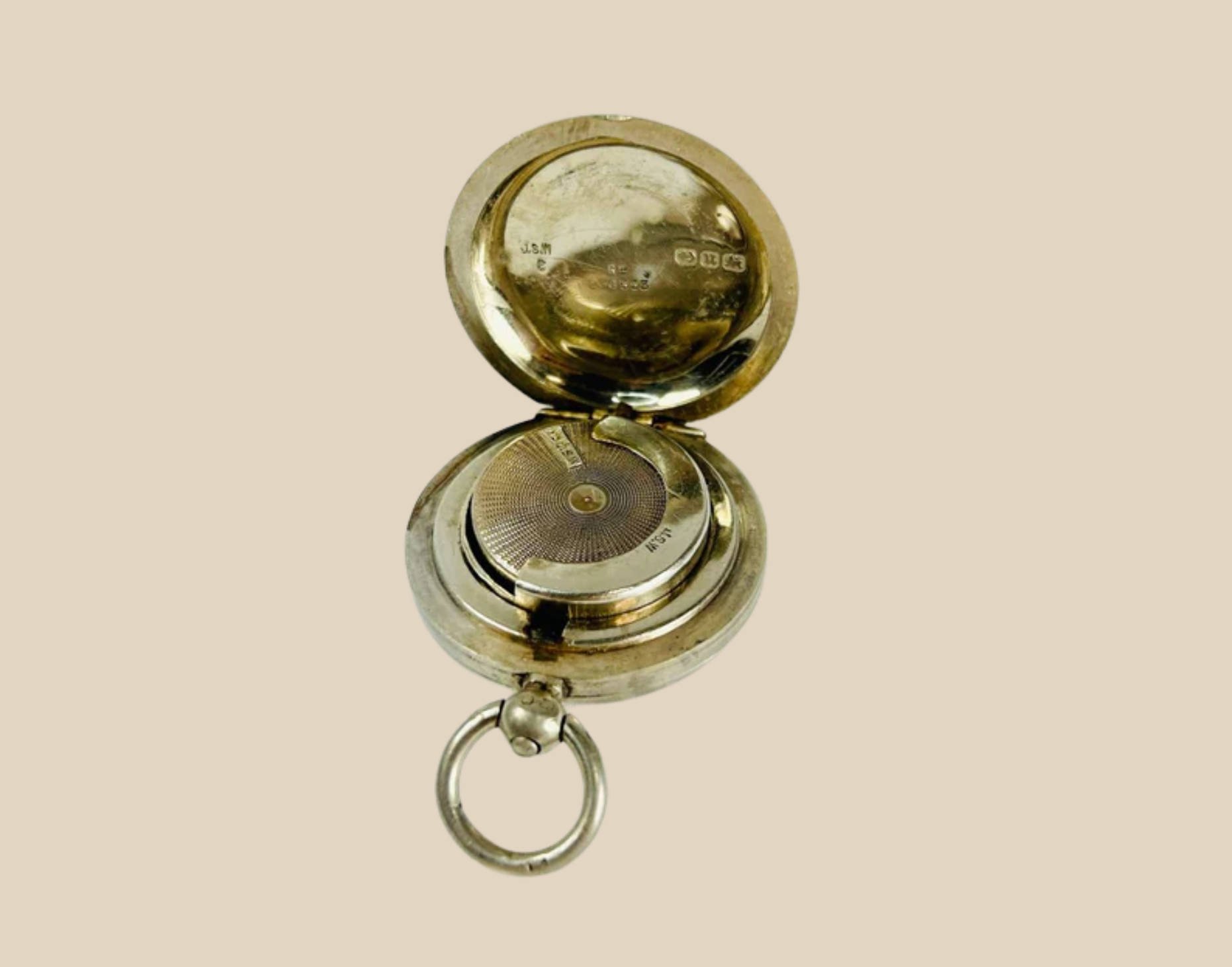 Antique brass pocket watch with open hinged cover and visible inner dial