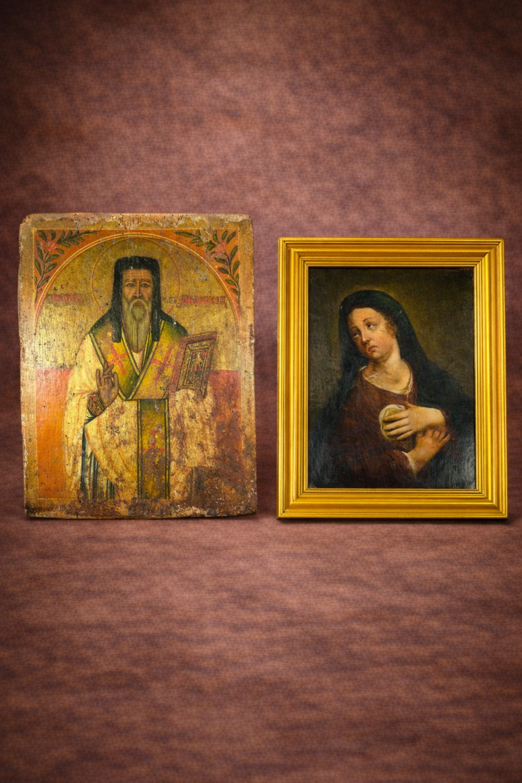 Antique Russian religious icon displayed beside an 18th-century European oil painting of the Virgin Mary in a gilded frame against a warm brown studio background.
