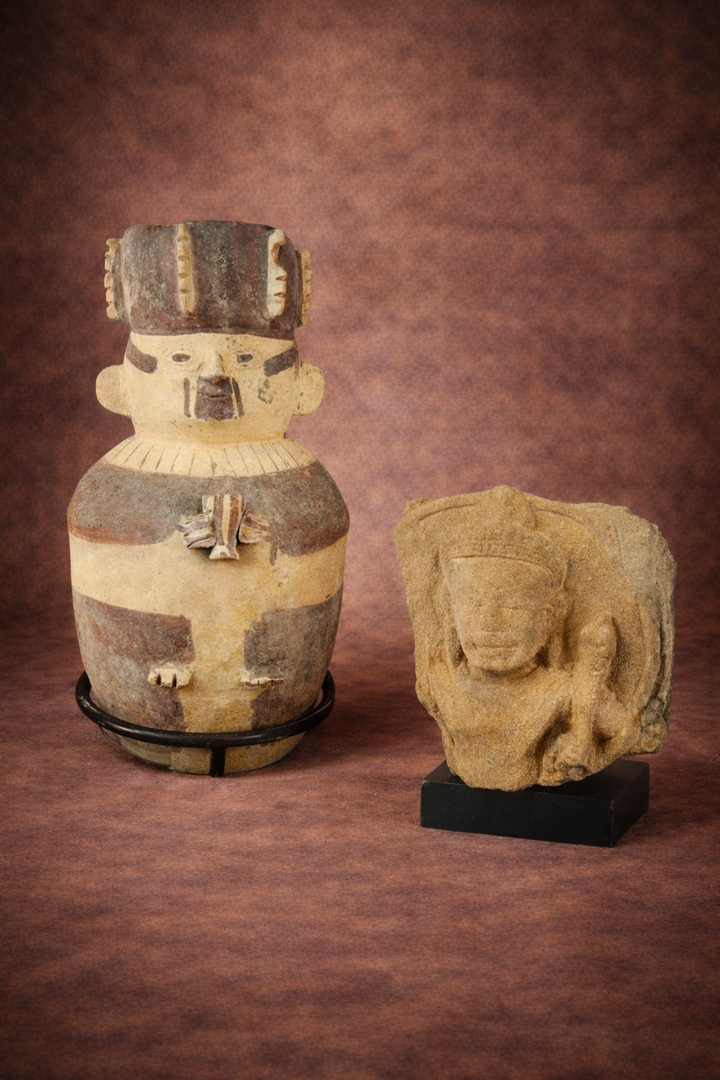 Pre-Columbian Chancay figural urn and 12th-century Khmer carved stone fragment displayed side by side.