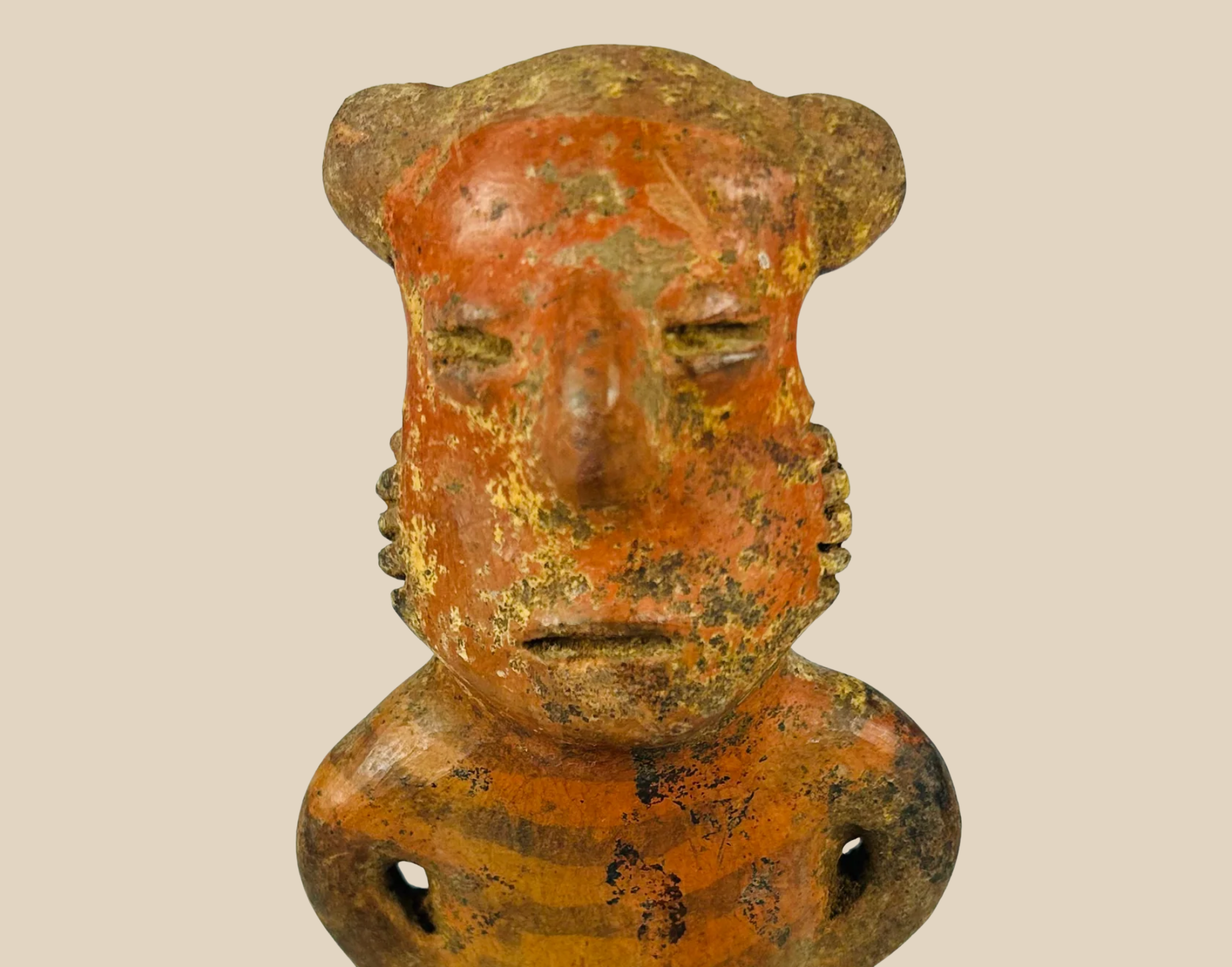 Ancient Pre-Columbian terracotta head fragment with worn surface and expressive facial features