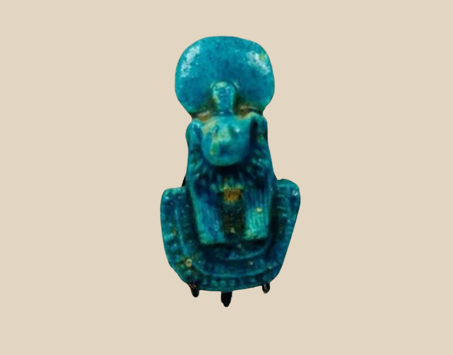 Ancient Egyptian blue faience amulet depicting the goddess Isis nursing Horus, displayed on a neutral background