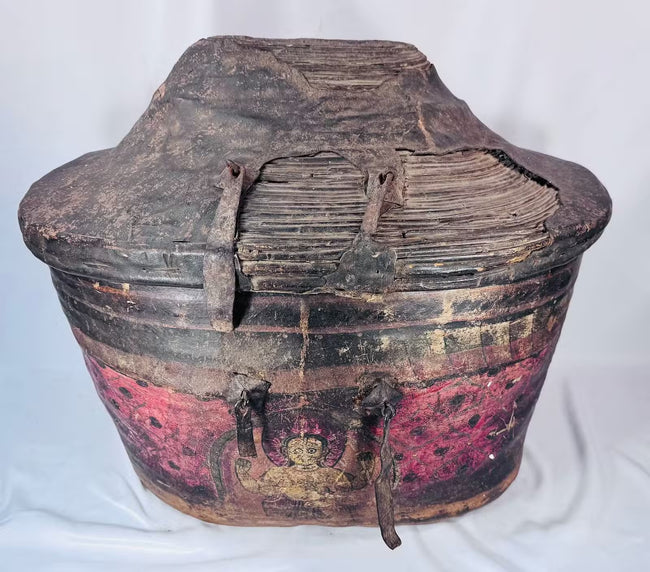 Painted deity figure on antique Himalayan hide-covered storage basket