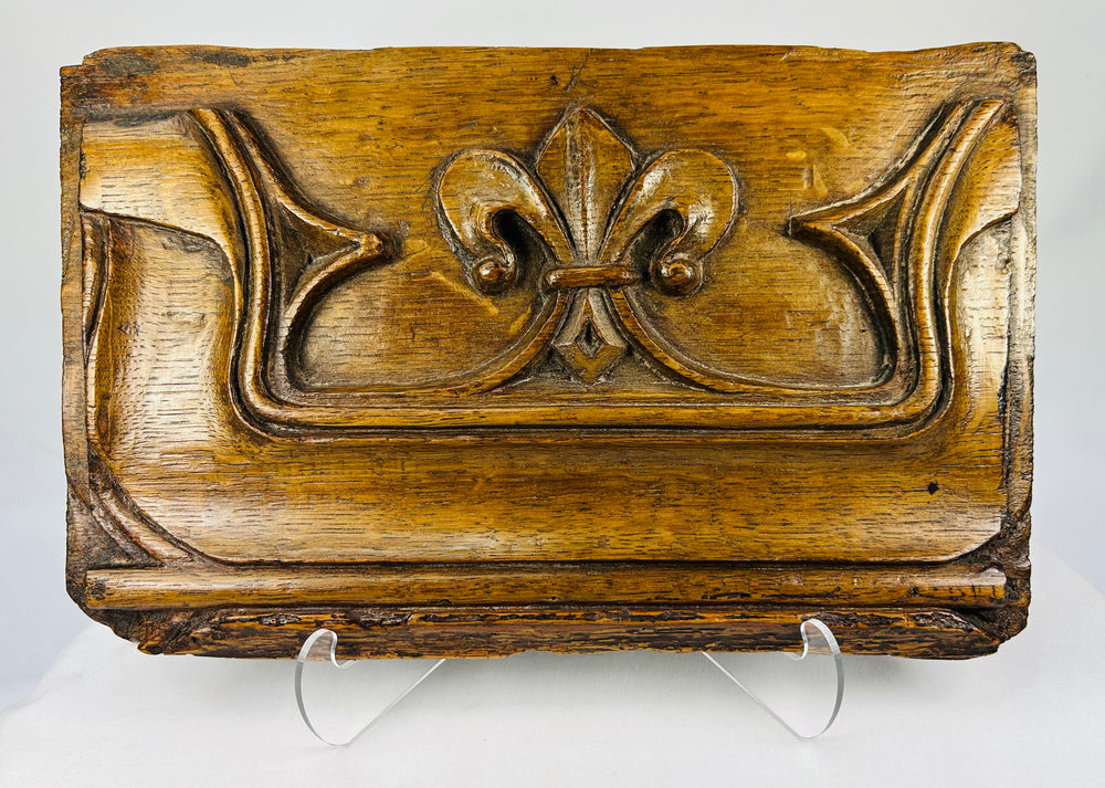 16th-century carved oak Gothic panel with fleur-de-lis motif on a white background