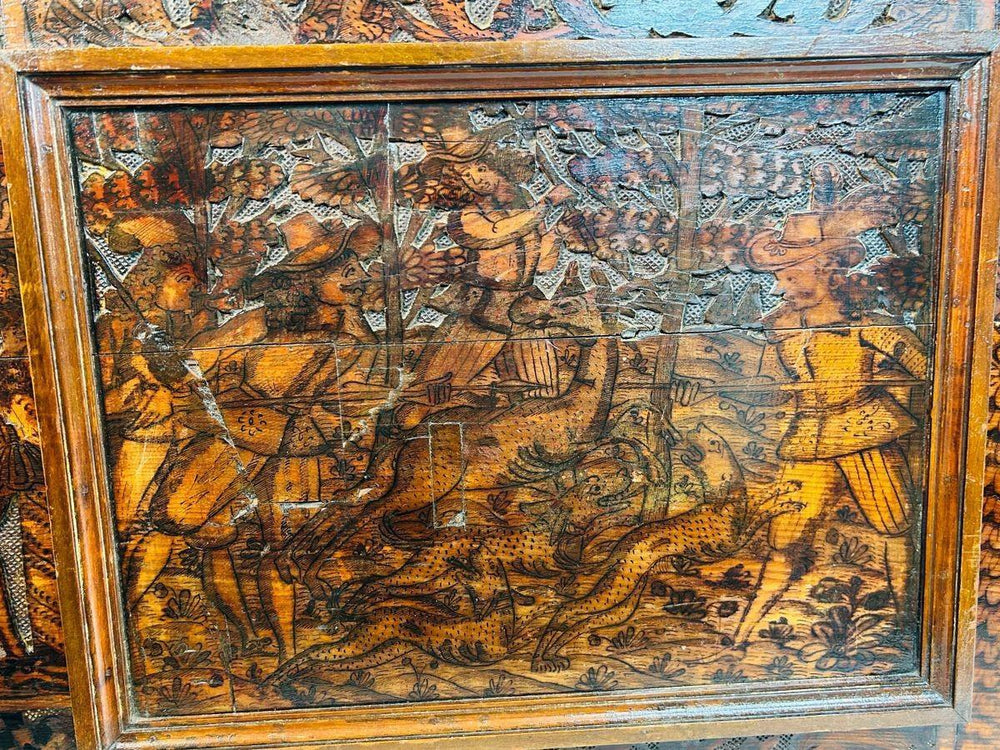 16th-century Renaissance carved wood panel depicting a detailed heraldic hunting scene with figures, animals, and ornate scrollwork.