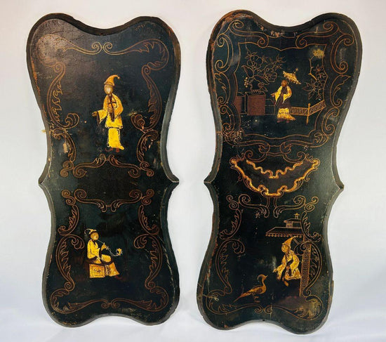 Pair of 19th-century Chinoiserie wall panels with hand-painted Asian-inspired figures, floral motifs, and gilt decoration on shaped black lacquered wood, circa 1850–1880.