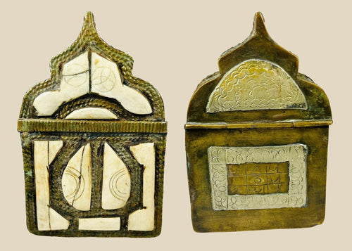 Ornate 19th-century Moroccan Berber amulet box with hinged pointed-arch lid, hammered brass body, carved bone inlay with geometric designs, and rich patina, used to house protective talismans and Quranic verses