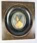19th-century miniature portrait of a lady wearing a bonnet in an oval frame