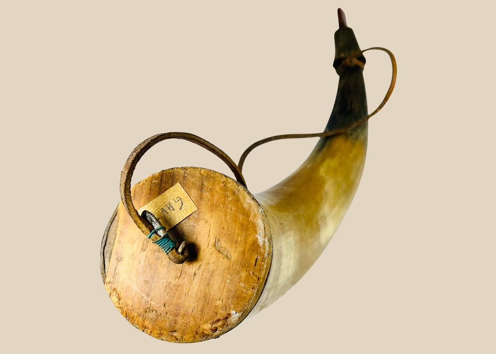 19th-century North American antique powder horn with wood base plug, leather strap, and aged patina