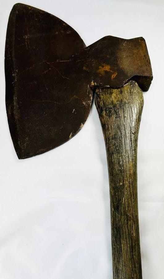 19th-century American broadhead axe with forged steel blade and flat reverse head, featuring a sturdy wooden handle, manufactured by M.H. Jones & Co., New York, used for woodcutting and frontier tasks.