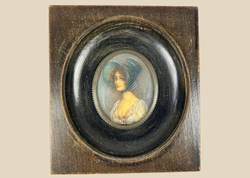 Antique 19th-century Viennese miniature portrait of a woman in blue bonnet and lace gown, painted in gouache on wafer, in original ebonized wooden frame with convex glass.
