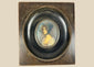 Antique 19th-century Viennese miniature portrait of a woman in blue bonnet and lace gown, painted in gouache on wafer, in original ebonized wooden frame with convex glass.