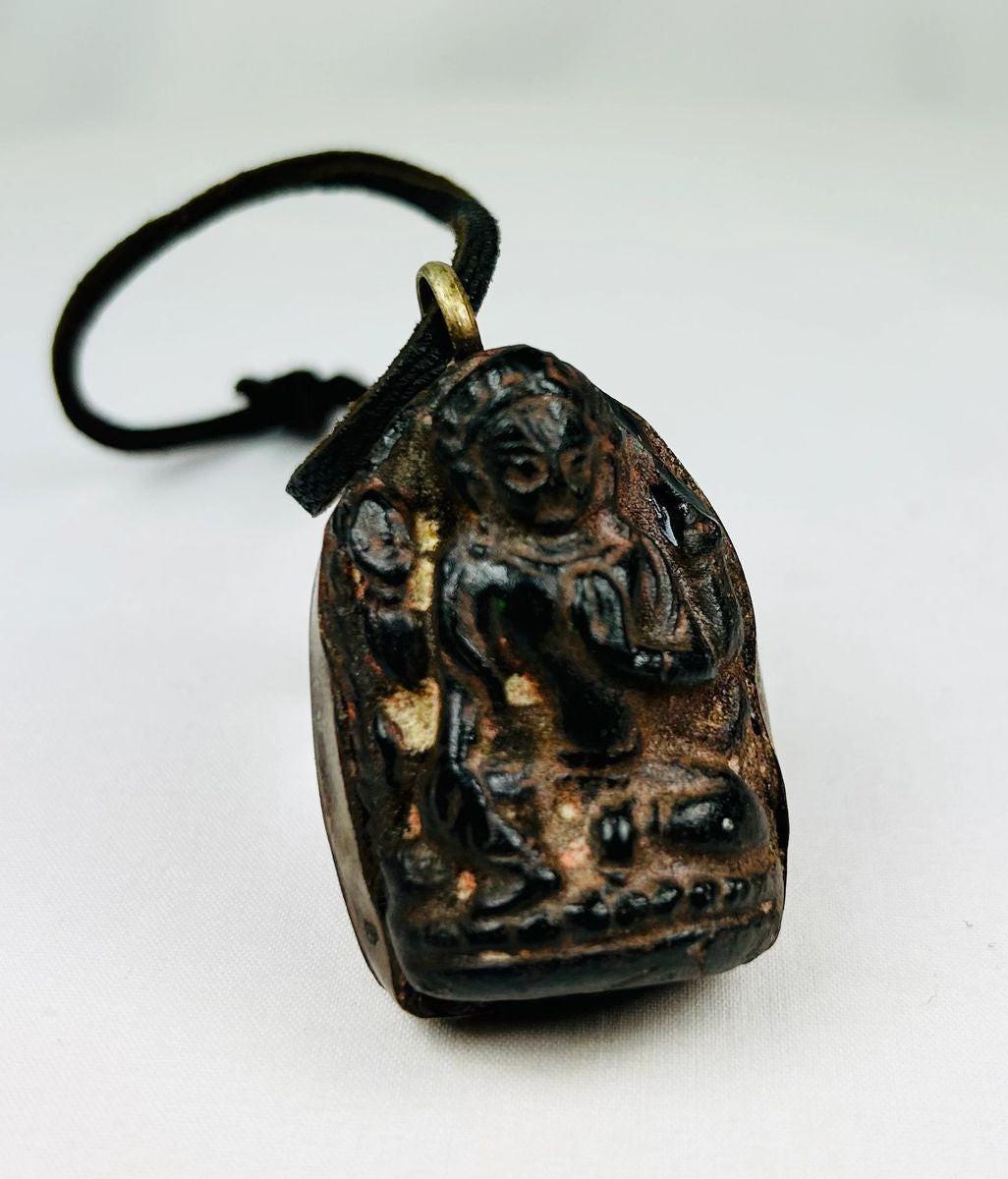 Antique Tibetan/Nepalese bronze Buddha amulet pendant, circa 1880–1920, with shrine-style niche, sealed brass back, original leather cord, and aged patina. Traditional devotional reliquary used for spiritual protection and meditation.