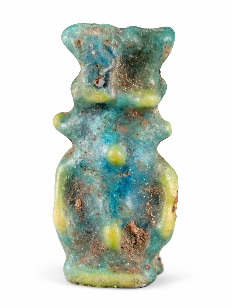 Small Egyptian faience Bes amulet with turquoise glaze and suspension hole for wearing as a charm.