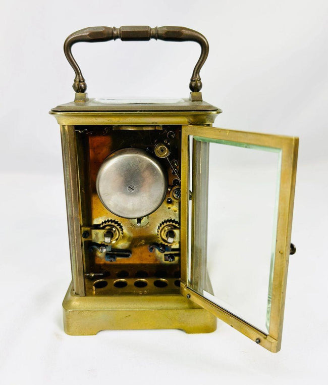 Rear view of antique French brass carriage clock showing maker’s mark and movement access panel.
