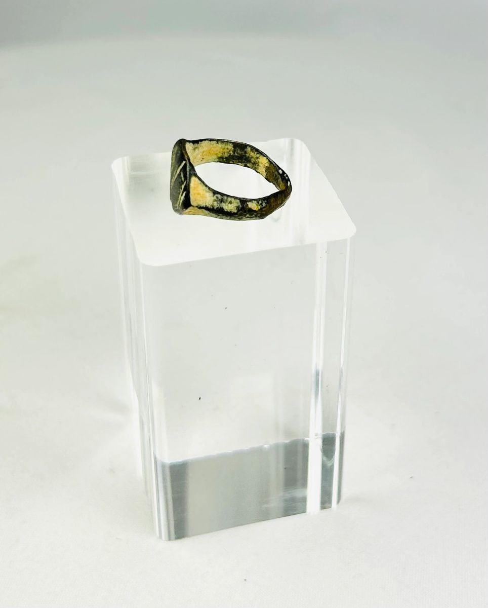 Side profile of an ancient Roman bronze ring revealing solid cast band construction