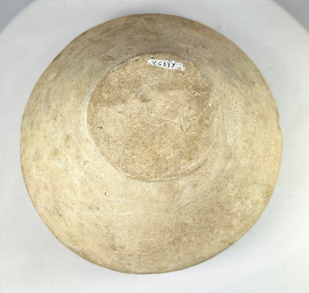 Rear view of ancient Harappan bowl showcasing detailed slip-painted fish patterns and linear motifs.