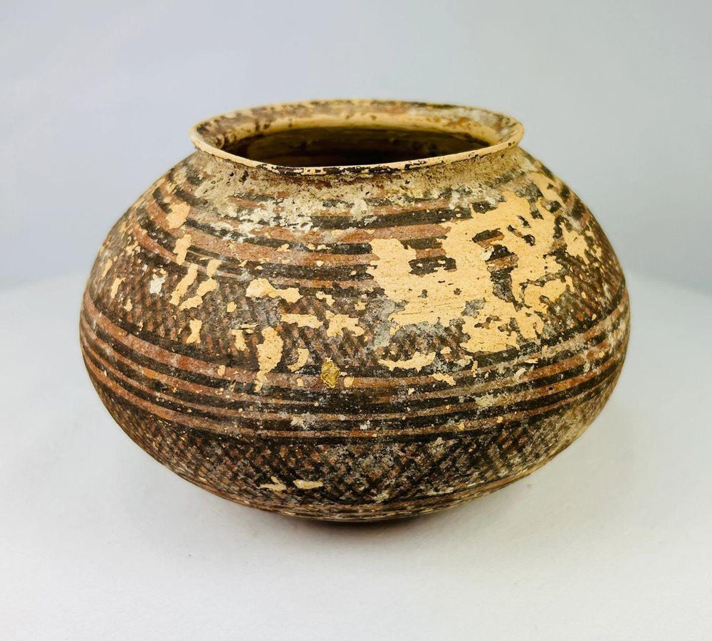 Ancient Indus Valley pottery vessel with black and red painted patterns