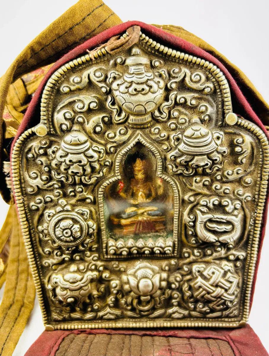 Tibetan portable gau shrine in embroidered fabric case with silver Buddhist symbols