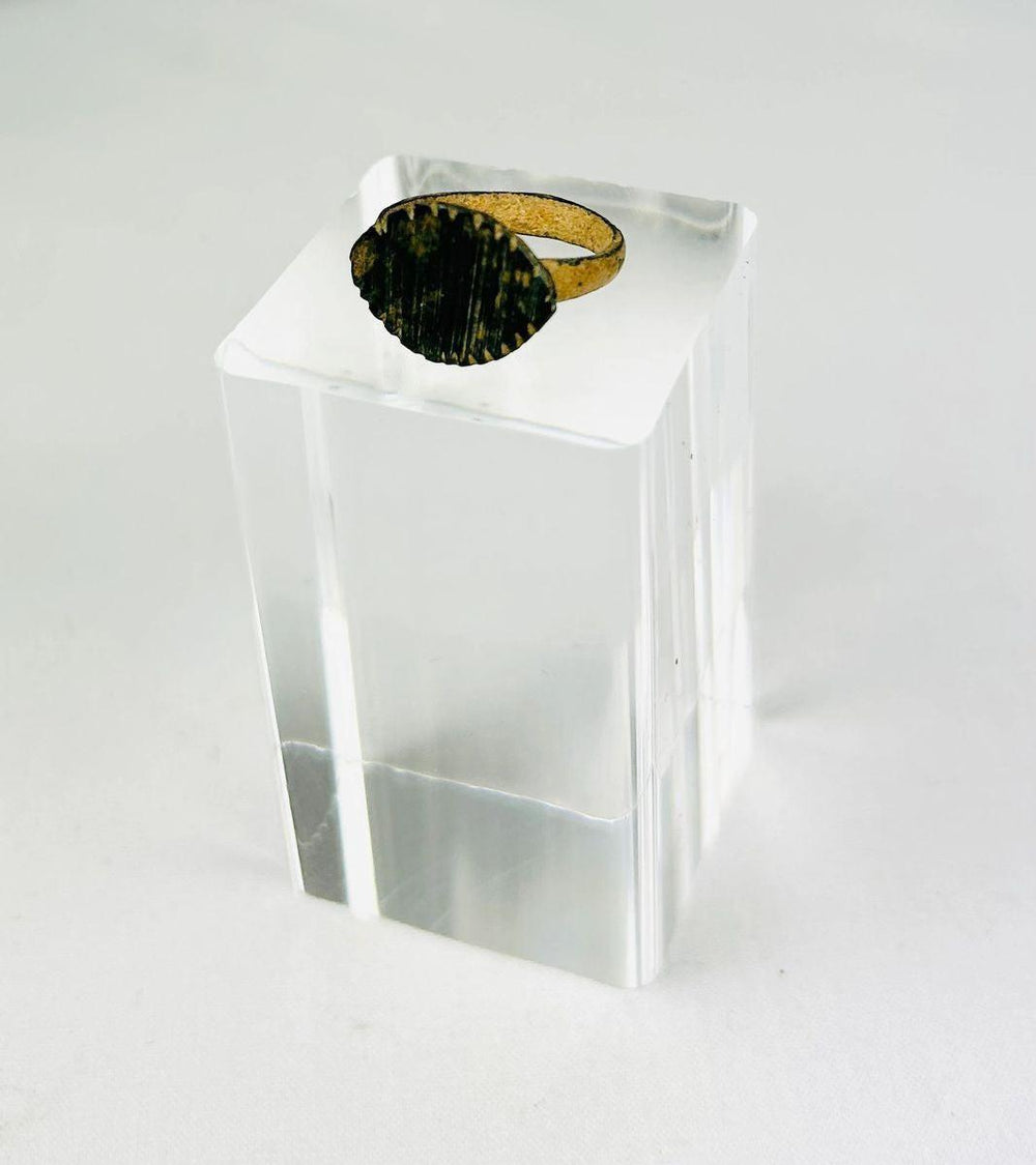 Detailed view of incised linework on an ancient Roman bronze ring bezel