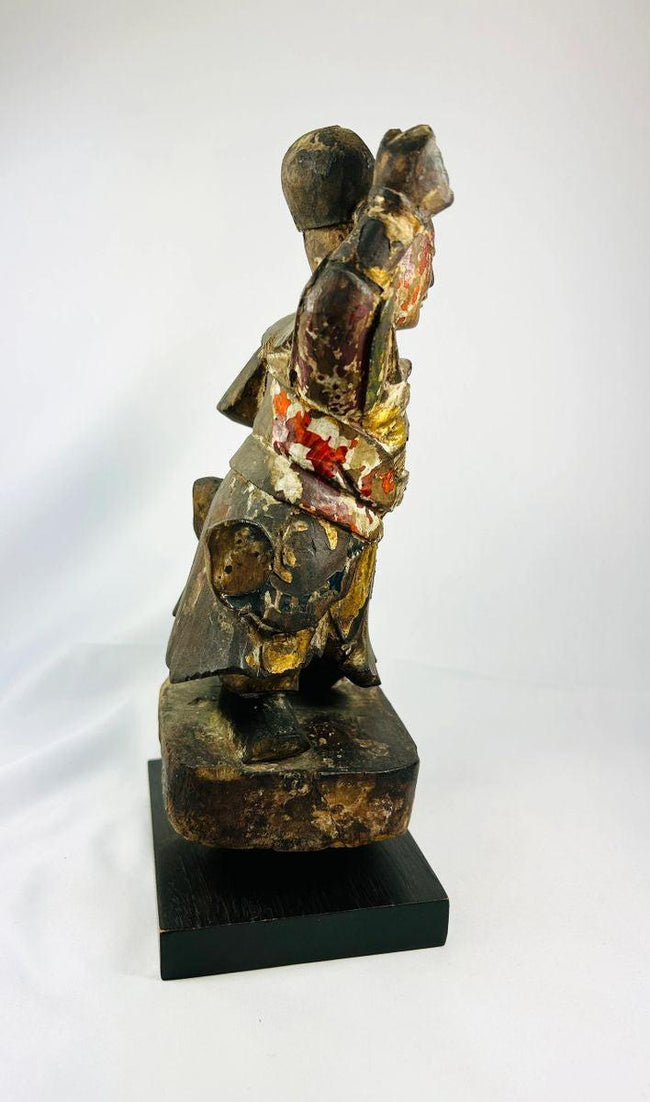 Antique Chinese Buddhist guardian figure Wei Tuo, carved and painted wood with traces of pigment, mounted on black display base.
