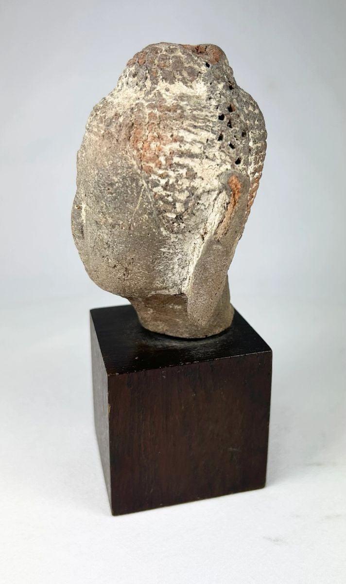 Southeast Asian Buddhist sculpture showing a terracotta Buddha head influenced by Gupta art