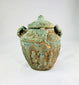 Close-up of Shang–Zhou bronze jar showing detailed surface motifs and verdigris patina, used for ancestral or ceremonial offerings, 2nd millennium BCE.