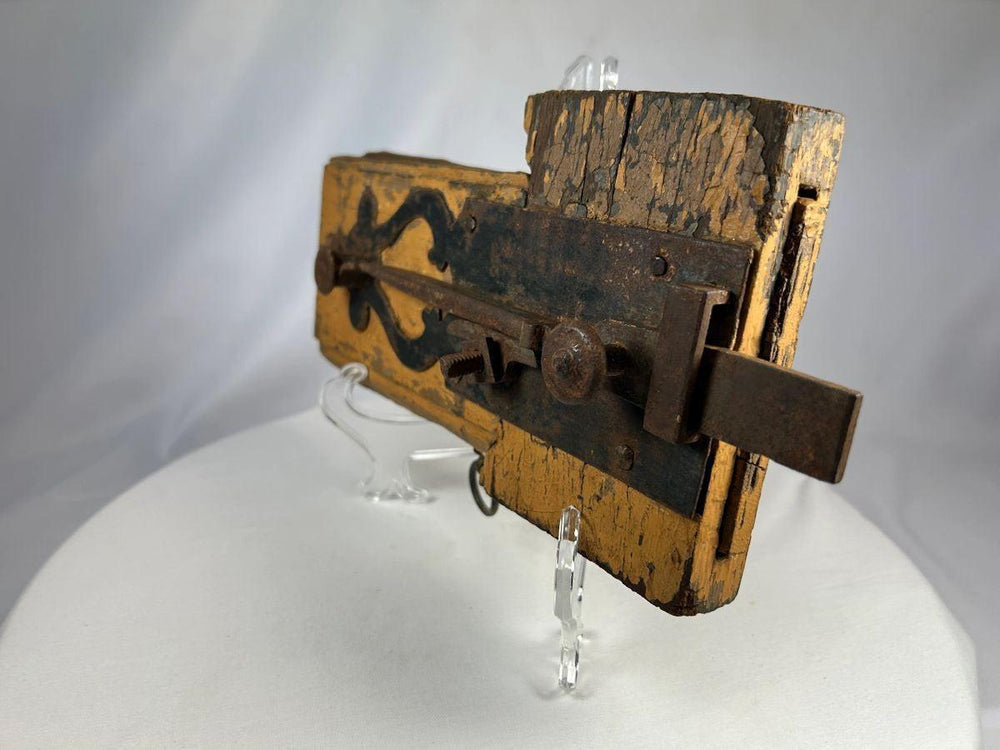 Close-up of hand-forged iron latch on an 18th-century wooden door lock