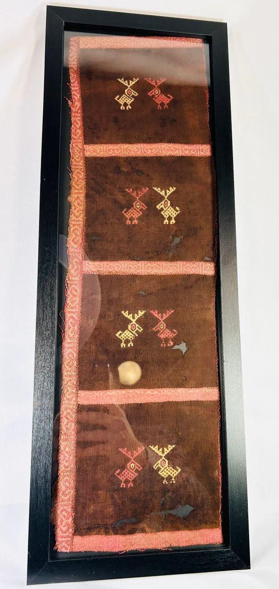 Close-up of geometric deer-like motifs on a Pre-Columbian textile