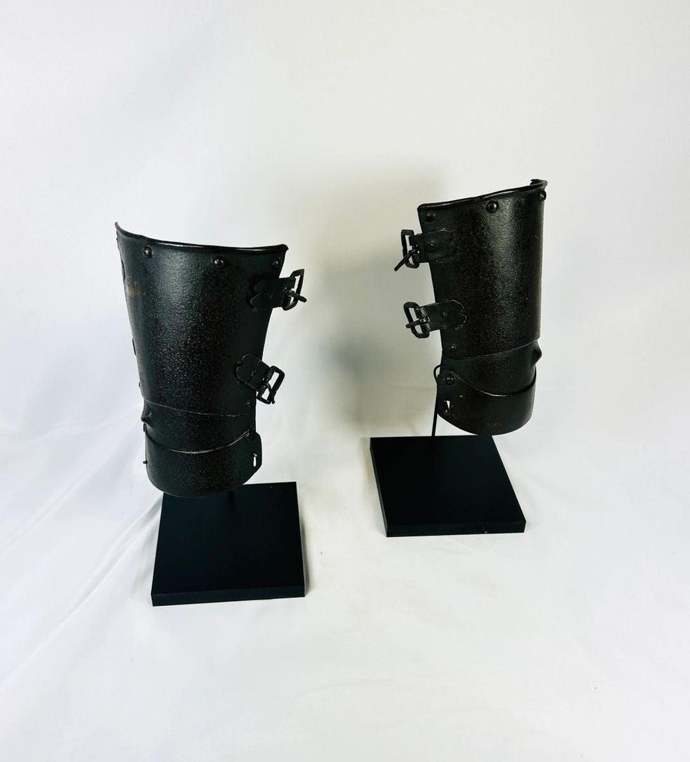 Pair of medieval Continental armour vambraces from the 15th–16th century, European steel forearm guards with riveted hinges displayed on black museum stands, Relic and Rarity.