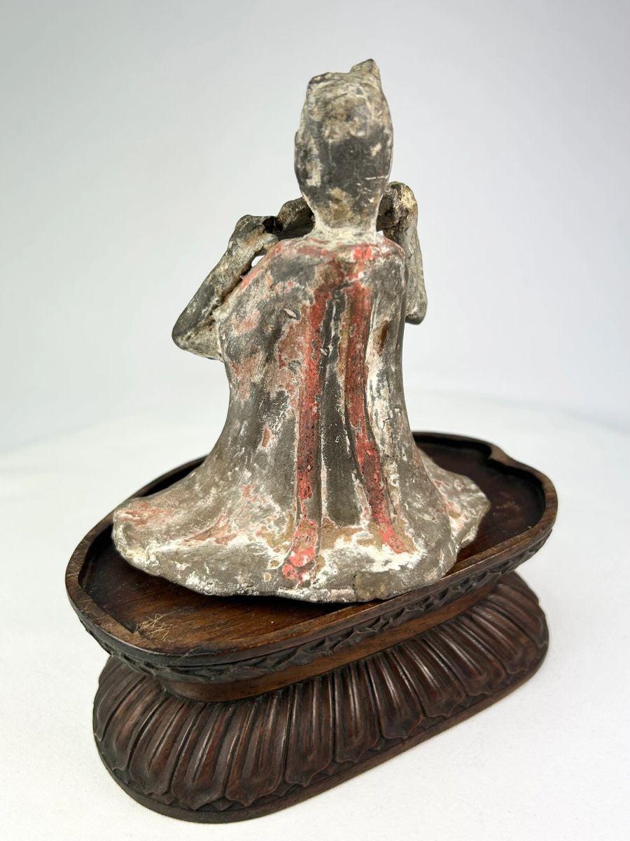 Seated Tang Dynasty female musician playing pan flute terracotta figure