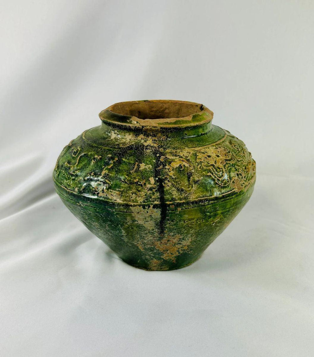 Detail shot of molded figures on Han Dynasty pottery jar showing craftsmanship and age.