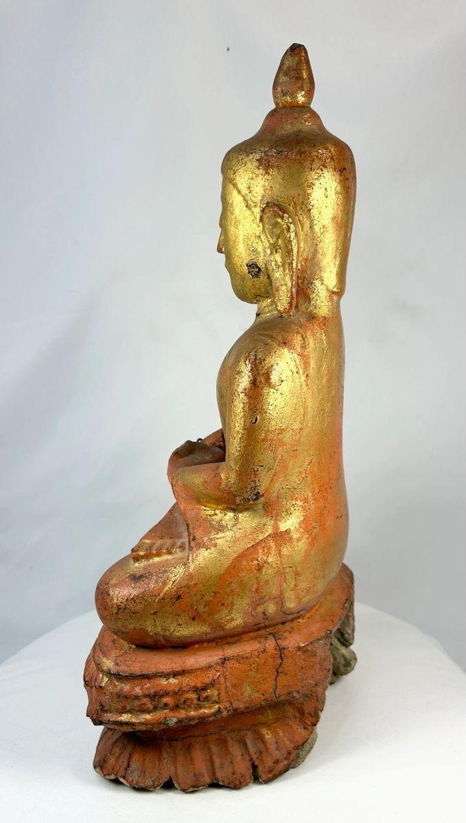 Detail of hand-carved robes on a large antique Burmese Buddhist monk statue