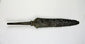 Antique iron spearhead with socketed base and heavy aged patina photographed flat.