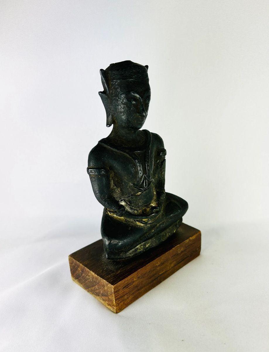 Museum-quality bronze Buddha statue with rich patina and devotional form