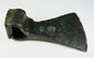 Close-up of historic European axe head displaying forging texture and oxidation