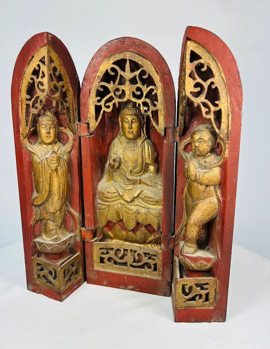 Antique Chinese folding Buddhist altar featuring central deity with attendant figures