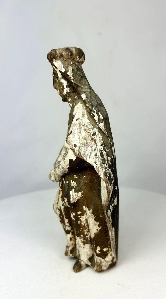 Historic Catholic santo figure showing open-hand blessing pose, carved wood with natural cracking and faded gilded pigment, Spanish Colonial religious art.