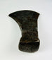 Close-up photo of antique forged iron axe head with visible blacksmith hammer marks and weathered surface.
